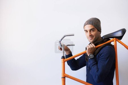 Photo for Bicycle, portrait and man in building carrying bike for healthy and eco friendly transportation for travel. Mockup, smile and cyclist with apartment complex, confidence and journey for travel commute. - Royalty Free Image