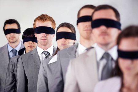 Business people, blindfold and employees lost at work, together and coworkers trust in workplace. Blind, team and collaboration in uncertainty, control strategy and support in challenge or workforce.