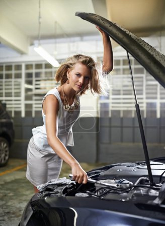 Photo for Woman, fashion and portrait or car engine for fix with spanner for maintenance for breakdown, mechanical or oil leak. Female person, face and vehicle bonnet or parking garage, auto repair or tools. - Royalty Free Image