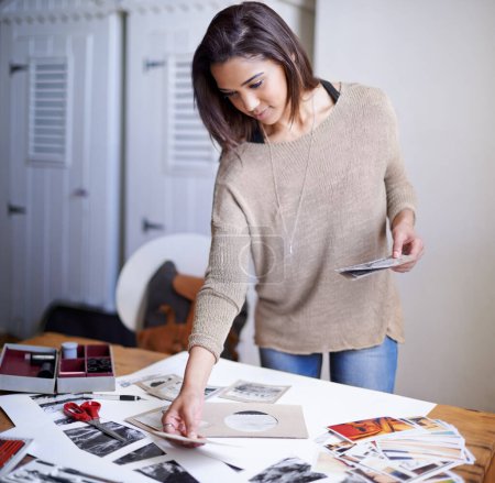 Woman, photographer and portfolio picture or creative decision for concept board, planning or inspiration. Female person, images and print outs on desk for art career for project, proposal or studio.