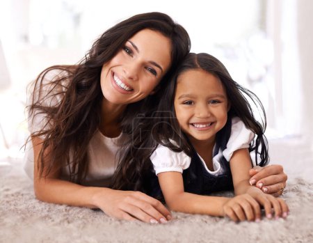 Photo for Happy mother, portrait and child lying on floor in relax for bonding, love or care together at home. Face of mom, parent and little girl, daughter or kid with smile in living room for family time. - Royalty Free Image