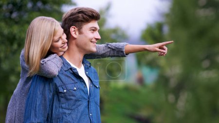Photo for Couple, smile and happiness with pointing finger in park, outdoor setting and bonding with activities. Relationship, goals and romance with fun day in forest for lifestyle, wellness and relax. - Royalty Free Image