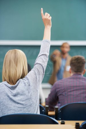 Photo for Student, hand up and question teacher at lecture for learning development or university, scholarship or behind. Person, finger and professor at chalk board in classroom or lesson, knowledge or Canada. - Royalty Free Image