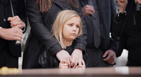 Photo for Child, sad and family at funeral at graveyard ceremony outdoor at burial place. Death, grief and group of people with casket or coffin at cemetery for service while mourning a loss at event or grave. - Royalty Free Image