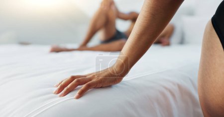 Photo for Couple, bed and hands on duvet for love, romance or intimacy in affection, morning or seduction at home. Closeup of woman and man or lovers lying in bedroom for compassion, anniversary or date. - Royalty Free Image