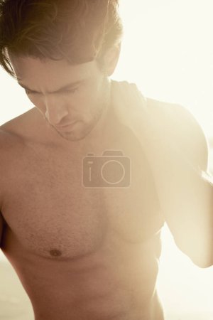 Photo for Sunset, muscular and man with holiday, beach and tropical island with weekend break and getaway trip. Person, bodybuilder and guy with lens flare and seaside with aesthetic and outdoor with fitness. - Royalty Free Image