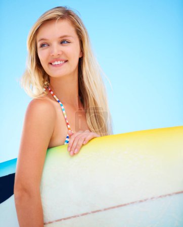 Photo for Surf, board and woman at beach thinking about summer, vacation and holiday mock up space. Happy, face and person outdoor in sunshine on blue background with confidence and a smile for watersports. - Royalty Free Image