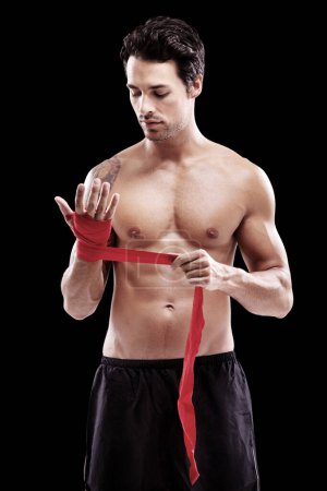 Photo for Man, hand wrap and fitness with boxer in a studio ready for boxing training and workout. Body, athlete and male fighter from Brazil with exercise, sport and wellness for battle with black background. - Royalty Free Image
