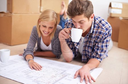 Photo for Couple, floor plan and blueprints with moving boxes for renovation, new home or property investment. Man, woman and happy thinking or development for real estate design for mortgage, buy or coffee. - Royalty Free Image