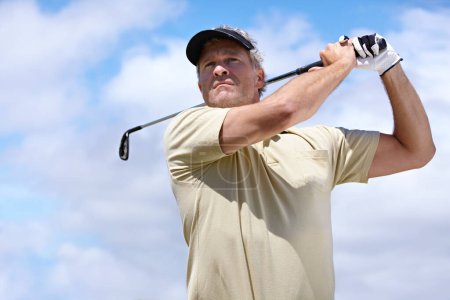 Photo for Sport, man and golf outdoor with swing for playing, performance or game with fitness and wellness. Athlete, mature person and golfer with club, blue sky and exercise for recreation, workout and hobby. - Royalty Free Image