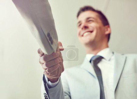 Photo for Handshake, business people and agreement in partnership, teamwork and thank you for recruitment. Male person, low angle and deal for merger in workplace, collaboration and support in cooperation. - Royalty Free Image