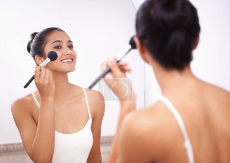Photo for Happy woman, face and makeup brush in mirror for beauty, cosmetics or grooming in bathroom at home. Female person smile and applying foundation, blush or contour for facial treatment in reflection. - Royalty Free Image