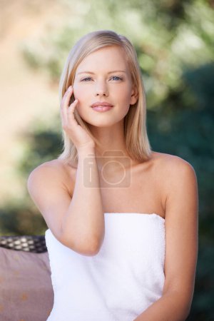 Photo for Spa, portrait and woman in towel outdoor for beauty, healthy skincare and body wellness. Relax, touch face and person at salon for pamper treatment, luxury therapy or calm peace of girl in nature. - Royalty Free Image