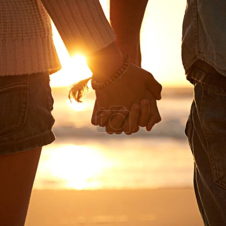Photo for Couple, holding hands and beach sunset for love at waves or vacation journey, peace or support. Partnership, fingers and environment at ocean for calm holiday or healing relationship, travel or trust. - Royalty Free Image