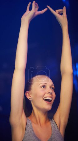 Rock, fan and woman at concert dance in celebration of music, event or festival with energy at night. Person, party and smile in audience with support for metal rave with freedom and happiness.