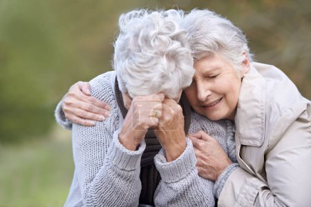 Photo for Senior woman, empathy and crying in nature, depression and grief in outdoor environment. Elderly people, garden and comforting or consoling in park, sadness and friend hugging for care in retirement. - Royalty Free Image
