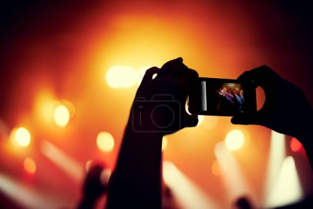Téléchargez les photos : Mains, smartphone ou image de groupe lors d'un concert, d'un événement musical ou d'un public avec lumière en bokeh. Personne, photographie ou image sur téléphone portable, technologie ou célébration avec foule à la performance disco. - en image libre de droit
