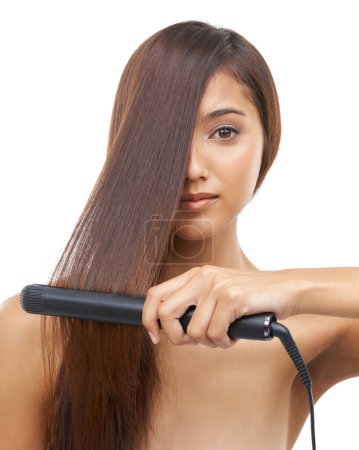 Photo for Hair care, straightener and portrait of woman in studio for cosmetic, salon and beauty treatment. Flat iron tool, confident and young female person with healthy hairstyle routine by white background - Royalty Free Image