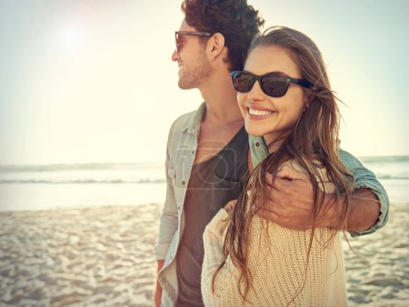Photo for Couple, sea and sunglasses with hug, smile or care for fashion, eye protection or vacation in summer. Man, woman and embrace in glasses at beach for sun, happy and love by ocean on tropical holiday. - Royalty Free Image