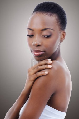 Photo for Skincare, touch and face of black woman in studio with shoulder, natural makeup and healthy glow. Cosmetics, dermatology and beauty model girl on grey background for skin care, shine or wellness - Royalty Free Image