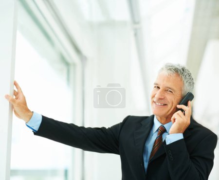Photo for Mature employee, smile and phone call in office building talking to boss of corporate company for business. Executive, chat and happy for job in workplace, technology and connect for communication. - Royalty Free Image