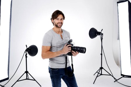 Photo for Photographer, portrait and smile with camera in studio for career, behind the scenes and backpack. Photography, person or happy with equipment, mockup space or shooting gear for photoshoot or passion. - Royalty Free Image