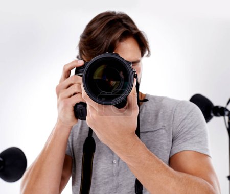 Photo for Man, camera lens and photography with tech in studio, press or media for news on white background. Photographer, photo journalist and creative with paparazzi, equipment and closeup in studio. - Royalty Free Image