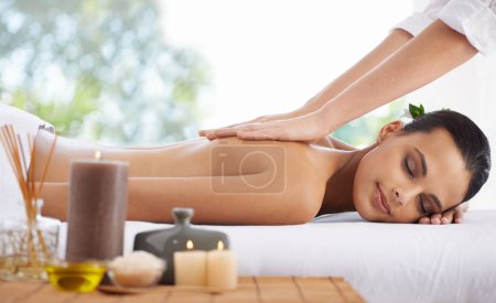 Photo for Happy woman, relax and back massage at spa for skincare, beauty or zen at hotel or resort. Calm female person or model lying on bed with masseuse hands in relaxation for stress relief or treatment. - Royalty Free Image