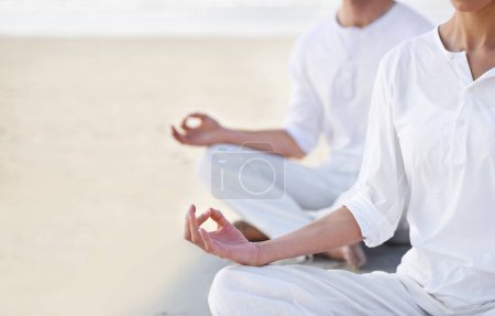 Téléchargez les photos : Lotus pose, couple et méditation sur la plage pour zen et bien-être avec guérison holistique en plein air pour le calme et le yoga. Océan, personnes et pleine conscience ensemble pour le lien, la paix et la nature spirituelle. - en image libre de droit