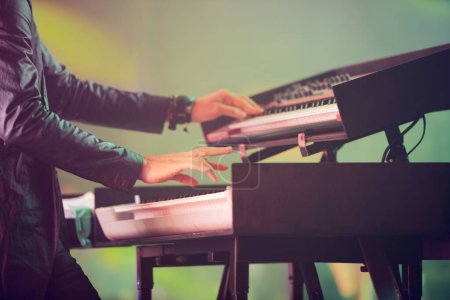 Photo for Musician, keyboard synthesizer and hands at stage playing at concert, music festival or live event in Amsterdam. Artist, performance and amplifier at outdoor party for fun, enjoyment and celebration. - Royalty Free Image