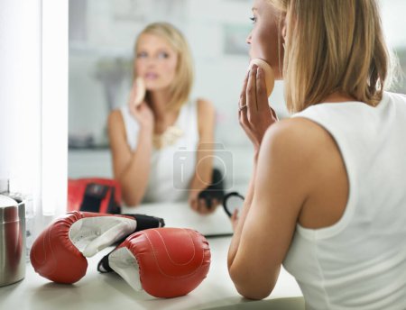 Photo for Female person, bruise and boxing gloves by mirror, makeup and stylish outfit in dressing room. Woman, blush and eyeshadow for sport match, reflection and fashion to prepare for post interview. - Royalty Free Image