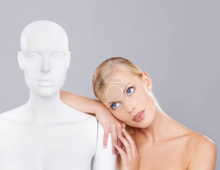 Photo for Woman, beauty and relax with mannequin, thinking and unique skincare with wellness on white background. Inspiration, natural cosmetics and dermatology with individuality, robot or dummy in studio. - Royalty Free Image