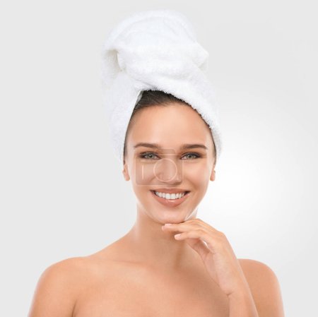 Photo for Portrait, woman and smile with head towel for skincare, wellness and beauty on light grey background. Happy, female person and laugh with glow for self care, dermatology and spa treatment with mockup. - Royalty Free Image