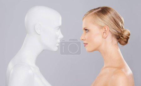 Photo for Studio, woman and mannequin with beauty clone versus artificial standard, perfect and facial wellness. Girl, doll and face in profile for cosmetics, plastic surgery or makeup on grey background - Royalty Free Image