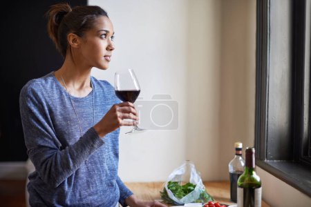 Photo for Woman, red wine and thinking in kitchen, reflection and future, drink and food for cooking at home. Relax with alcohol in glass, inspiration or insight with memory, enjoy and wellness with beverage. - Royalty Free Image