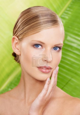 Photo for Woman, portrait and cosmetic beauty with leaf background for organic wellness for healthy skin, treatment or makeup. Female person, face and hand for fresh dermatology or natural, studio or mockup. - Royalty Free Image