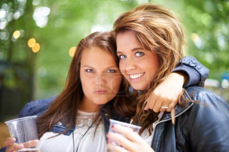 Photo for Portrait, hug and women with beer, music festival and happiness with weekend break and summer. Face, people and friends in a park and woods for an event and party with alcohol and concert with fun. - Royalty Free Image