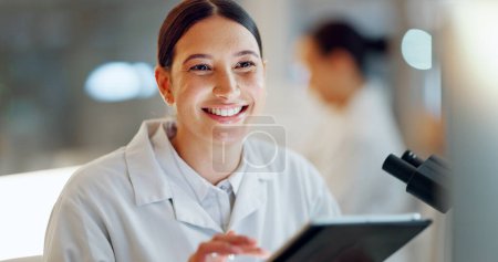 Photo for Scientist, woman and tablet, microscope or laboratory research for DNA analysis and happy with medical study. Student or science expert in biotechnology with digital software and lens check for data. - Royalty Free Image