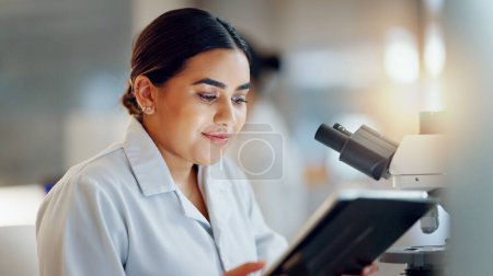 Photo for Scientist, woman and tablet, microscope or laboratory research for DNA analysis and happy with medical study. Student or science expert in biotechnology with digital software and lens check for data. - Royalty Free Image