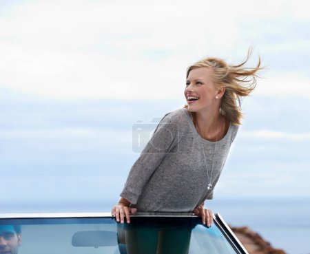 Photo for Happy, blue sky and convertible car with woman on road trip for travel, vacation or holiday in summer. Space, smile and journey with young person driving in vehicle for transport in fresh air. - Royalty Free Image