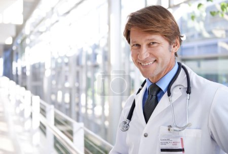 Photo for Happy, pride and portrait of doctor in hospital with positive, good and confident attitude. Smile, medical career and face of professional mature male healthcare worker in medicare clinic corridor - Royalty Free Image