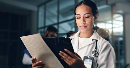 Photo for Doctor, woman and tablet with document, night and analysis for results, decision and info in hospital. Medic, digital touchscreen and paperwork for health, history and planning for thinking in clinic. - Royalty Free Image