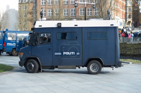 Photo for Police, van and city for transport, safety or protection service for public justice in in street. Vehicle, law enforcement and outdoor for danger, arrest and armored truck on urban road in Copenhagen. - Royalty Free Image