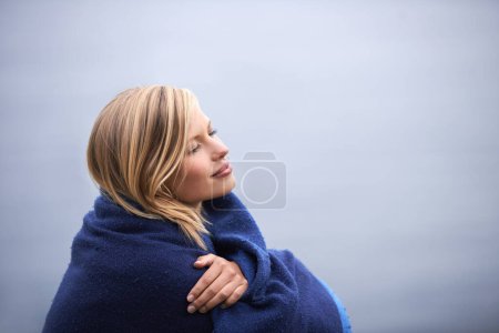 Photo for Closeup, woman and outdoor with blanket for holiday with smile, wellness and contemplate for leisure. Vacation, reflect with memories in nature for happiness, relax and healthy mindset with trip. - Royalty Free Image