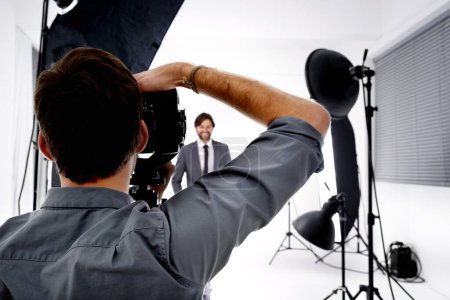 Photo for Back, model and photographer in studio, gear and pose with confidence and professional with equipment. Employee, freelancer and entrepreneur with lighting and campaign with style, tools and portfolio. - Royalty Free Image