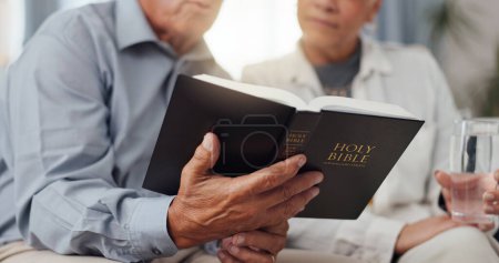 Photo for Couple, hands and home for reading bible, talking of faith and God with helping, support and scripture on sofa. Mature people or pastor in living room with holy book for religion and Christianity. - Royalty Free Image