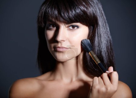 Photo for Beauty, skincare and portrait of woman with brush for makeup, foundation and studio. Blush application, dermatology and cosmetics with face of girl isolated on dark blue background space with tools. - Royalty Free Image