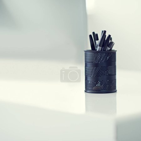 Photo for Pen, container and desk as writing stationery in office for organization of tools supply for drawing, signature or creative. Marker, holder and storage in New York or equipment, college or school. - Royalty Free Image
