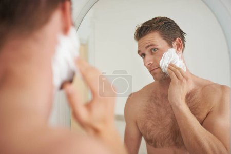 Photo for Mirror, skincare and man with shaving cream application in a bathroom for morning, routine or hygiene. Hair removal, foam and male person in a house with facial product for beauty, wellness or care. - Royalty Free Image