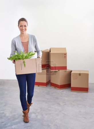 Photo for Portrait, new home and woman with boxes, moving and real estate with rental apartment and property. Person, plant and girl with achievement and personal development with package and house on a loan. - Royalty Free Image